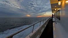 Side of cruise ship at dusk